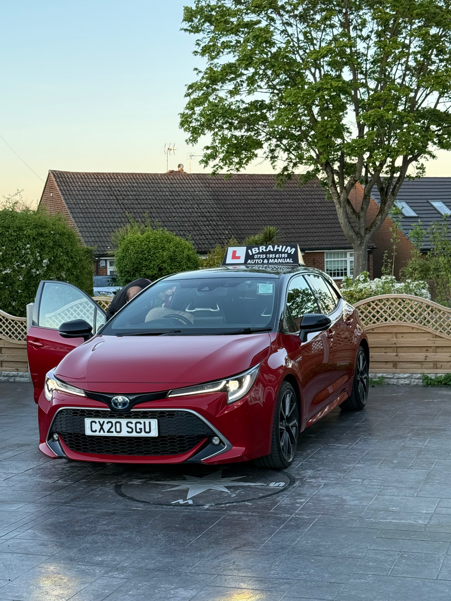 Ibrahim's red Toyota Corolla Hybrid driving school car in Derby